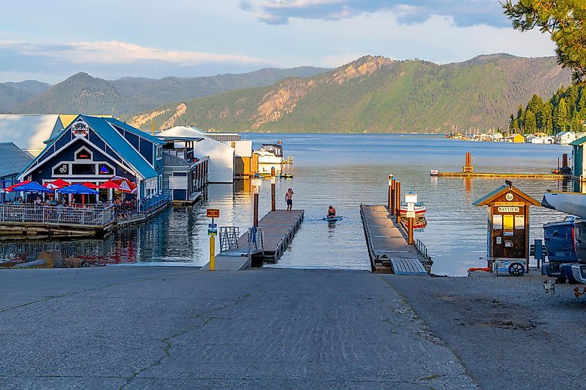  Wooden docks extend into the scenic bay at the marina on Lake Pend Oreille, with boat houses, cafes, and float homes nearby in Bayview, Idaho.