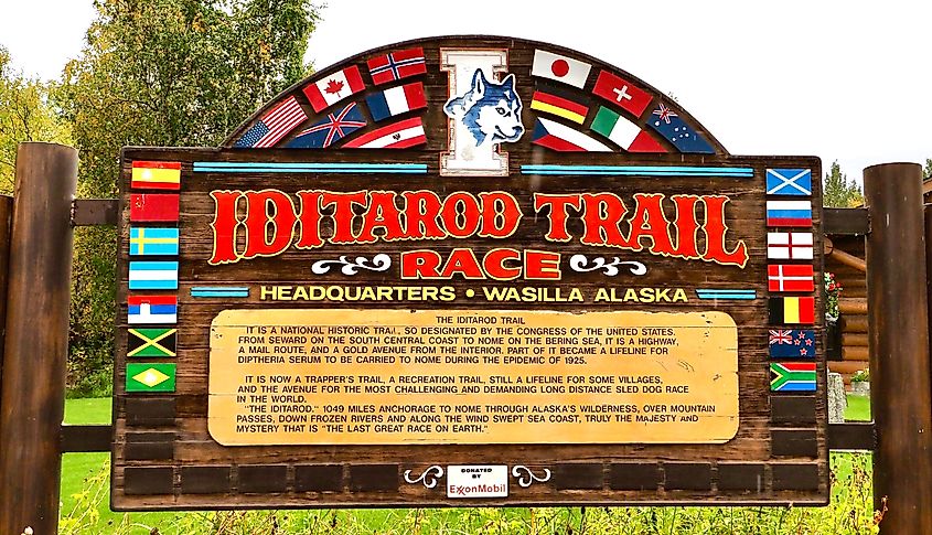 Editorial Photo Credit: The Old Major via Shuttestock. Wasilla, Alaska USA - September 10, 2024: The welcome sign at the headquarters of the annual Iditarod sled-dog trail race in Wasilla, Alaska.