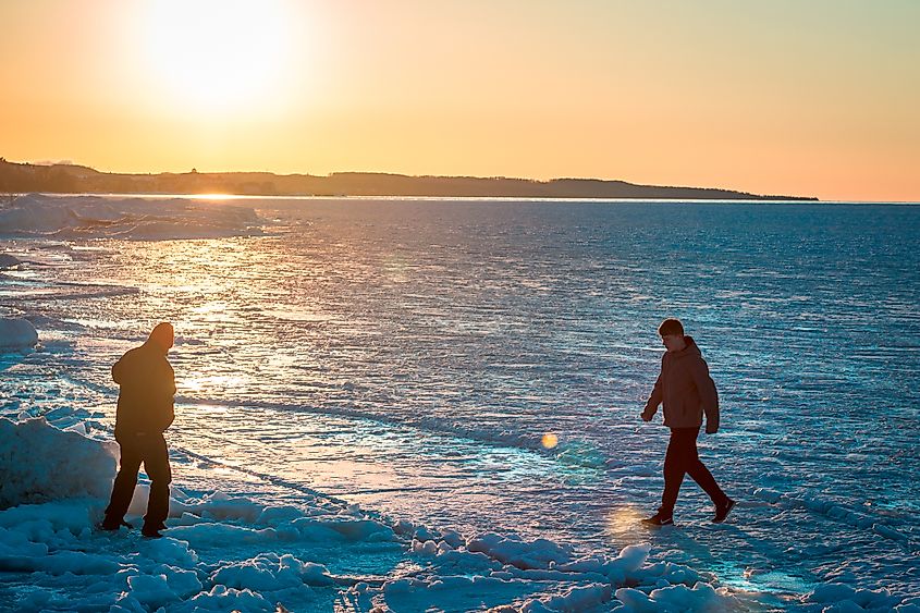 People walking on a frozen Lake Michigan in Petoskey, Michigan.