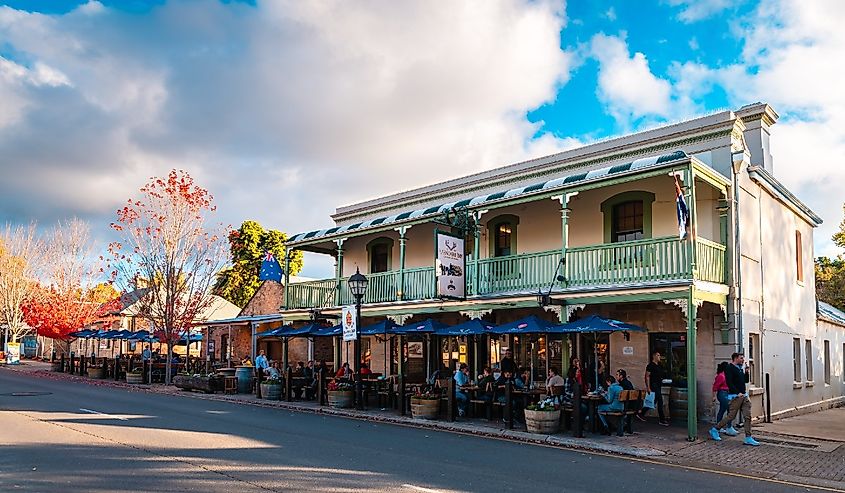 The Hahndorf Inn German restaurant with people sitting outside viewed from the Main street during autumn evening at sunset