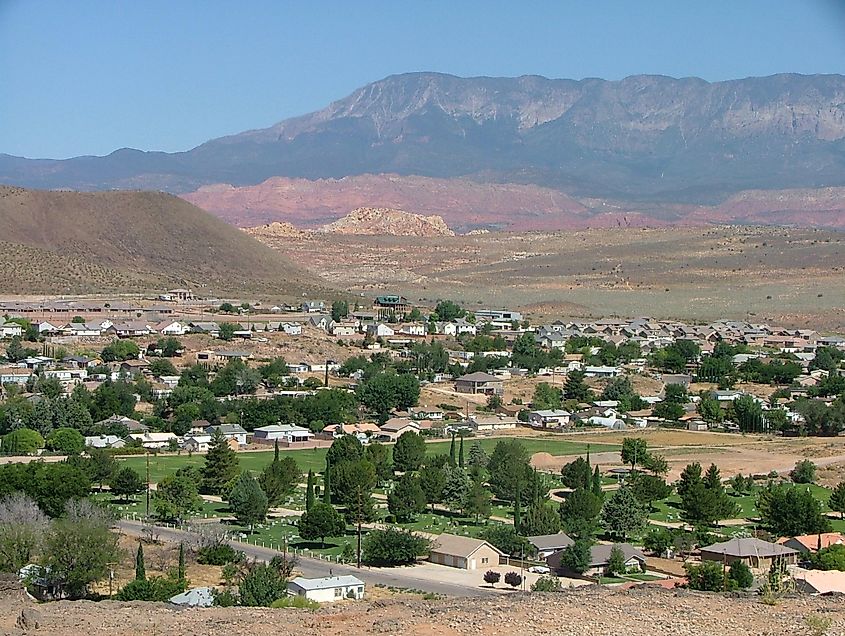Aerial view of the town of Hurricane, Utah, with mountains in the background.