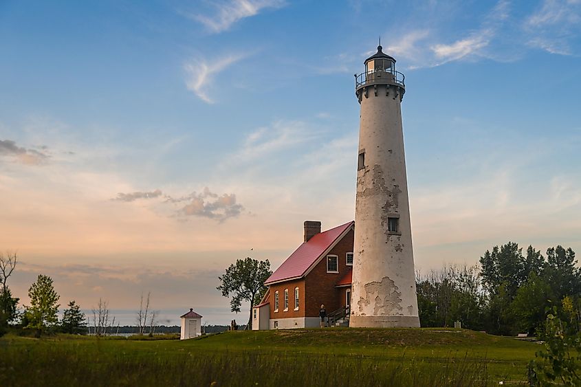 Sunset on the 67 foot tall Tawas Point Lighthouse which went into service in 1853. Now part of Tawas Point State Park, via Lester Graham / Shutterstock.com