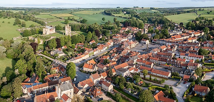 Aerial panorama of Helmsley Castle and the town at sunrise, with the North York Moors countryside surrounding it in North Yorkshire, England