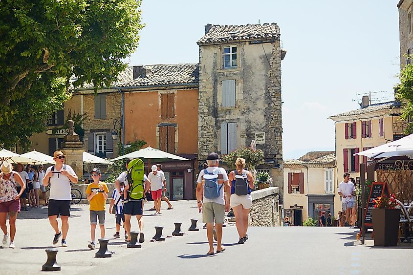 People walking through beautiful old streets of Gordes, Provence, France
