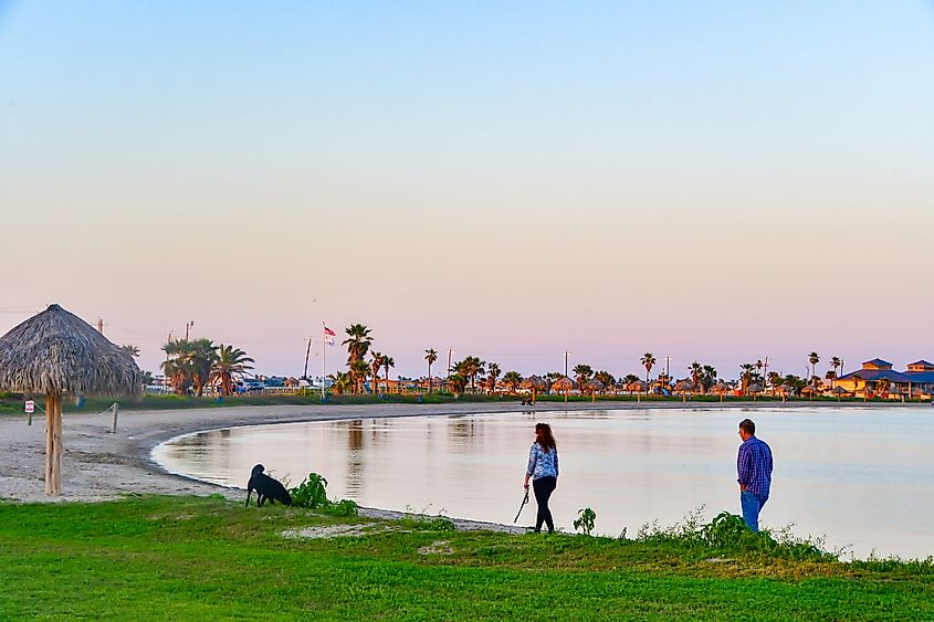 People enjoying a beautiful sunset at the beach in Rockport, Texas, USA .