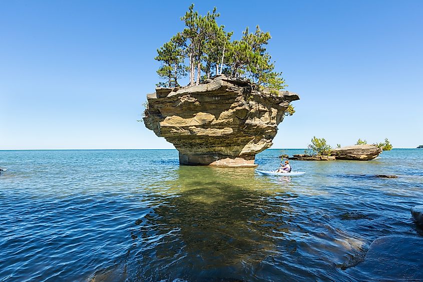 Turnip Rock rises from the shallow blue water of Lake Huron near Port Austin, Michigan.