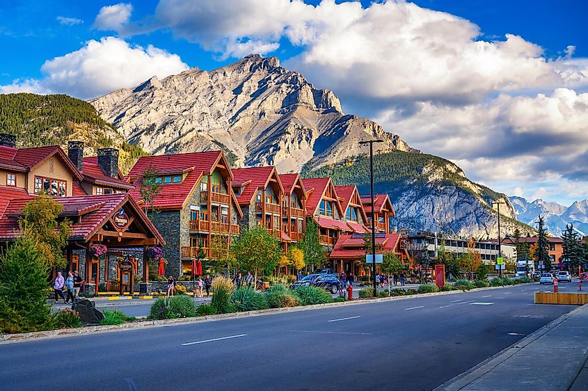 Scenic street view of the Banff Avenue with cars and tourists, via Nick Fox / Shutterstock.com