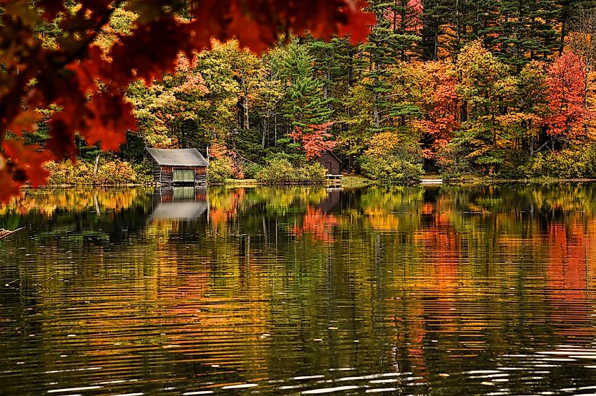 Fall foliage reflected in Chocorua Lake in Tamworth, North Conway, New Hampshire. Editorial credit: Rhona Wise / Shutterstock.com