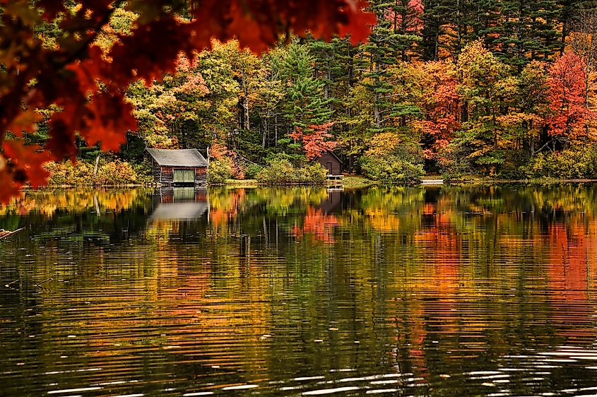 Fall foliage reflected in Chocorua Lake in Tamworth, North Conway, New Hampshire, via Rhona Wise / Shutterstock.com