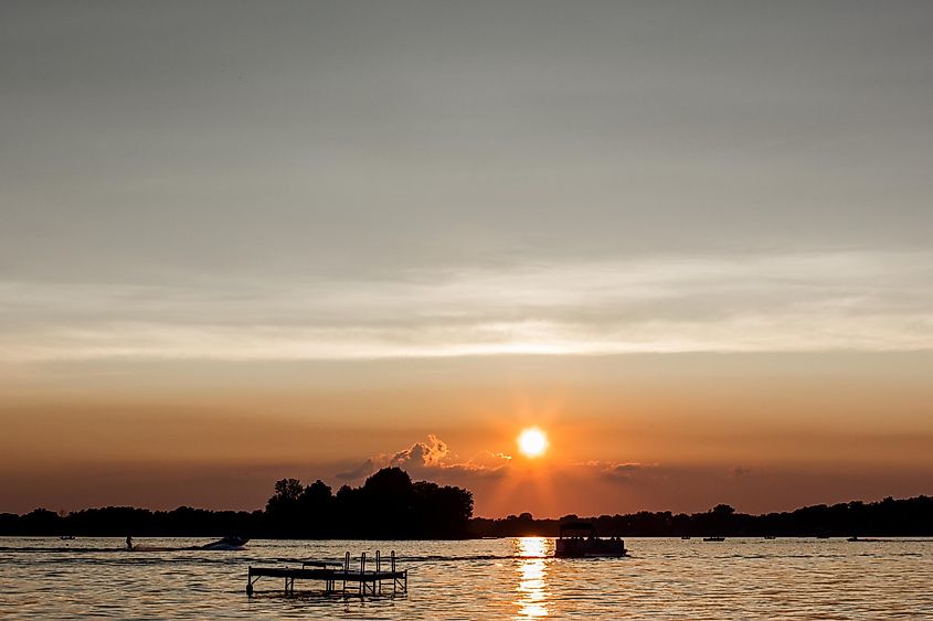 Deep sunset with warm oranges and blues over Dewart Lake near Syracuse, Indiana