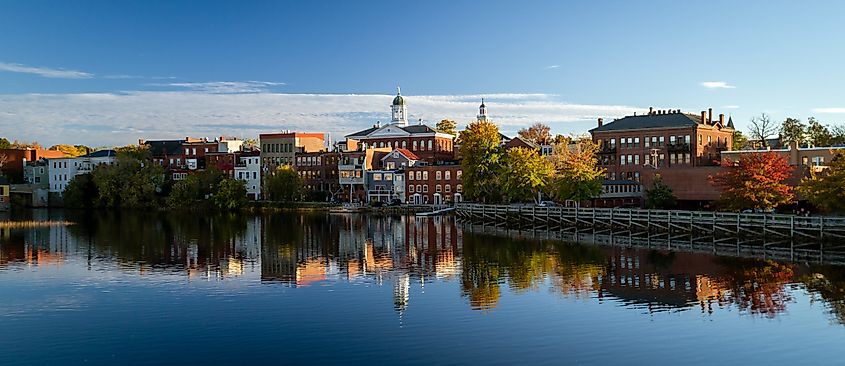 The river front buildings of Exeter, New Hampshire are seen reflected in the water.