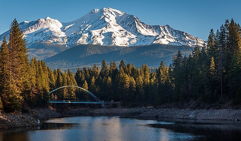 Snow-capped Mount Shasta and Suspension Bridge standing above Lake Siskiyou