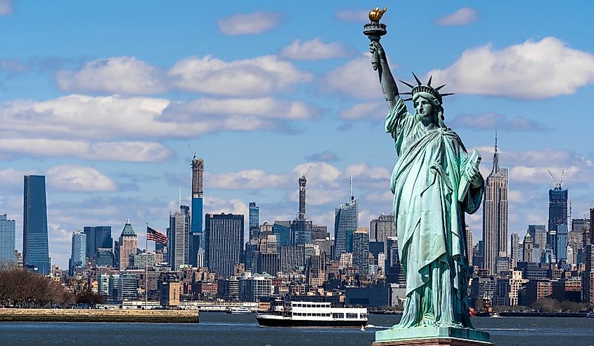 The Statue of Liberty over the Scene of New York cityscape river side which location is lower manhattan, Architecture and building with tourist concept