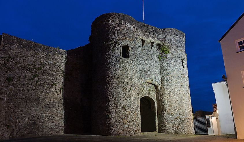 Carmarthen Castle at night. Made of stone and blue sky in the background. 