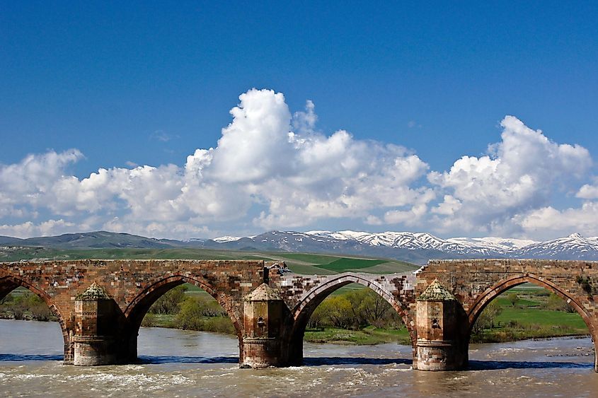 Cobandede Arc Bridge across Aras River with Kargapazari Mountains in background, Eastern Anatolia, Turkey