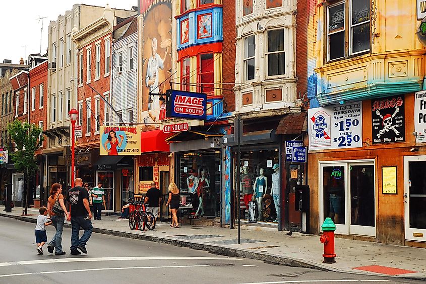 A family crosses South Street, an eclectic, funky shopping district in Philadelphia, Pennsylvania, via James Kirkikis / Shutterstock.com