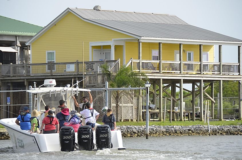 rand Isle, Louisiana, boat and elevated house, July 2021