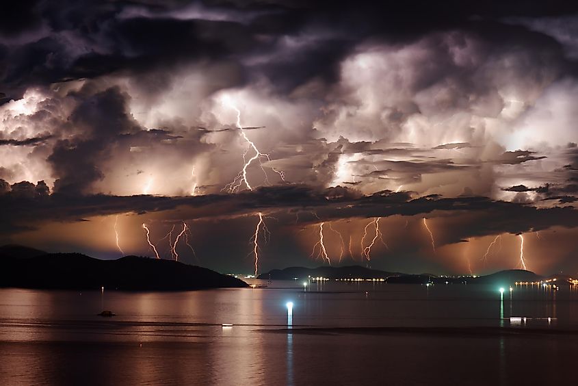 Beautiful view of dramatic dark stormy sky and lightning over Nha Trang Bay of South China Sea in Khanh Hoa province at night 
