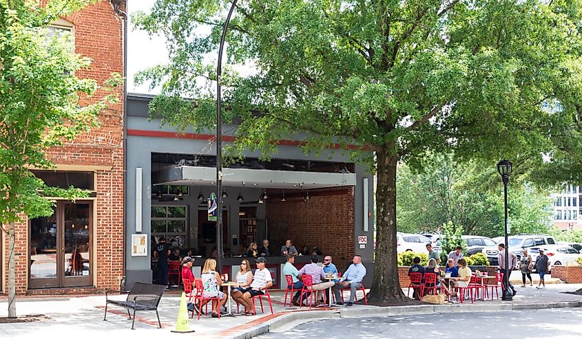 Mark's Grill, on Main St., showing diners at sidewalk tables, passersby on sidewalk in Greenville, South Carolina