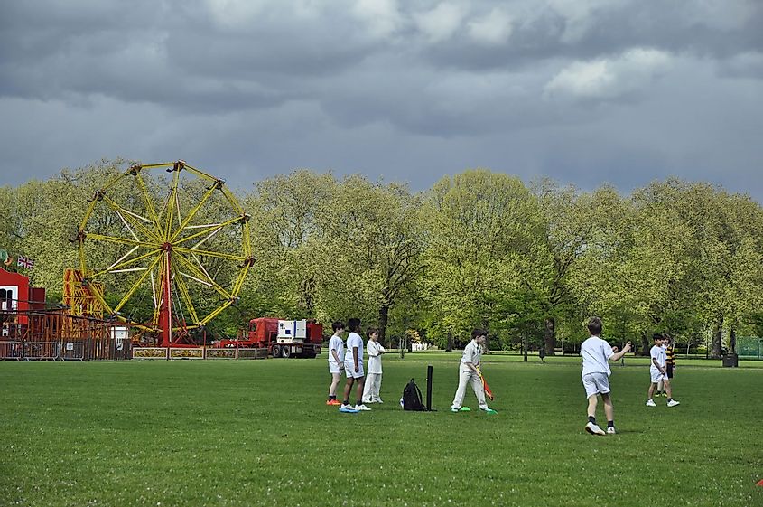 Kids playing cricket in Battersea Park