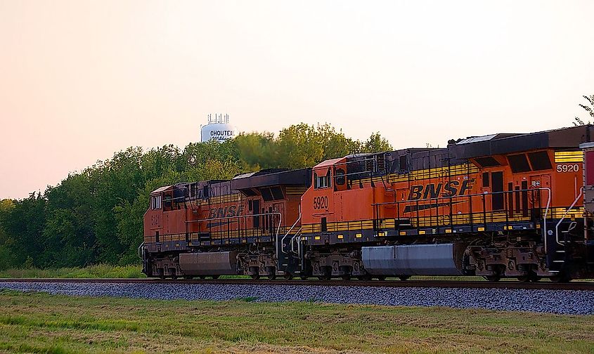 BNSF power, pulling a string of empy coal hoppers on Union Pacific's old Katy main, passes through Chouteau, OK - Home Of The Wildcats!