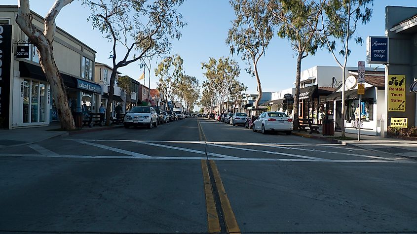 Main Street on Balboa Island, featuring charming shops and storefronts along a bustling street in a coastal community.