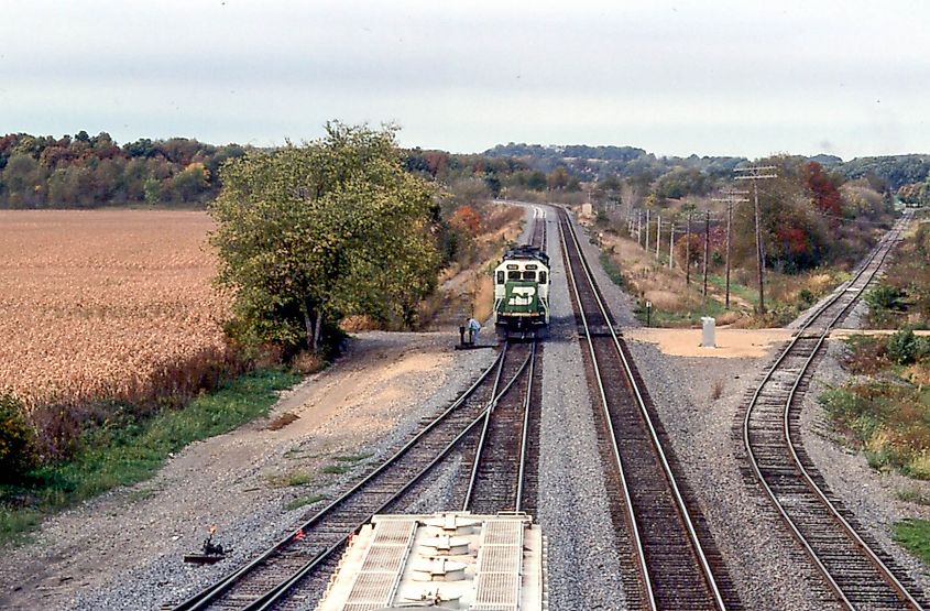 Train passing through Oregon, Illinois, surrounded by fall foliage