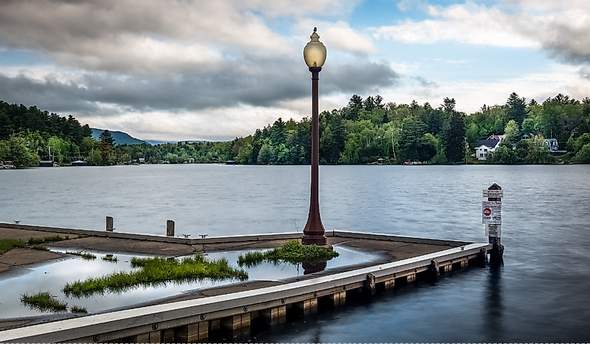 A dock and lamp post on a cloudy afternoon in the Adirondacks on Lake Flower at Saranac Lake, New York