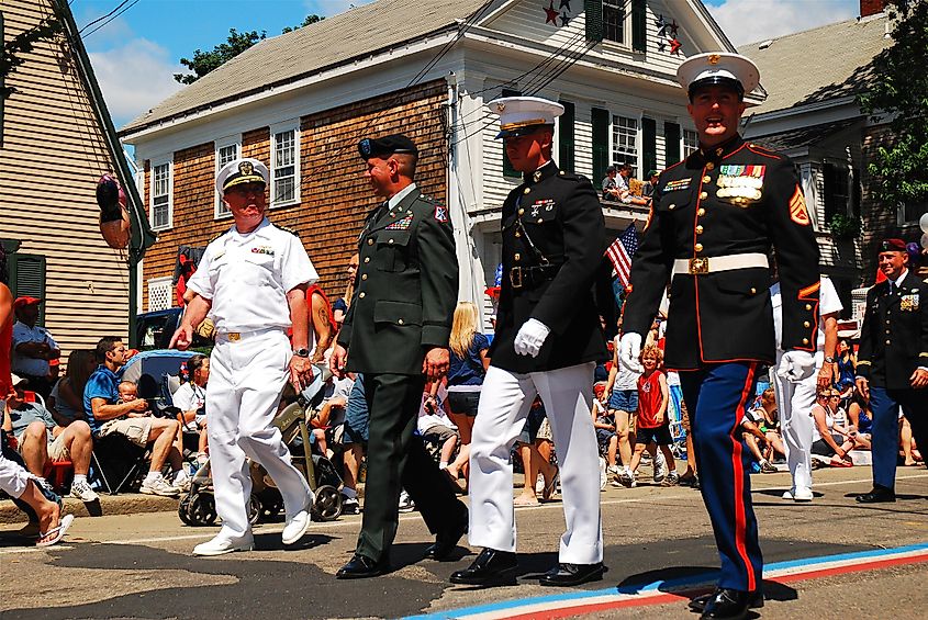 Members of all four United States armed services, in their formal dress, march in a Fourth of July parade in Bristol, Rhode Island.