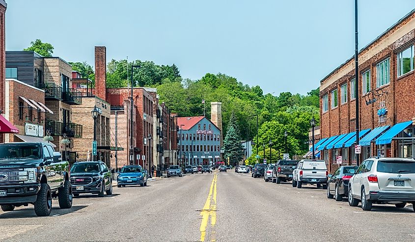 Stillwater, Minnesota, street view of the downtown stores and restaurants in historic buildings and cars parked alongside on a sunny day in summer