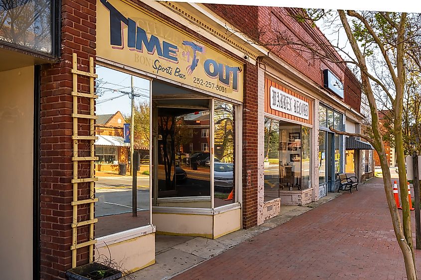 Storefronts including the Warren Record newspaper office and local businesses line a street in the historic downtown area of Warrenton.
