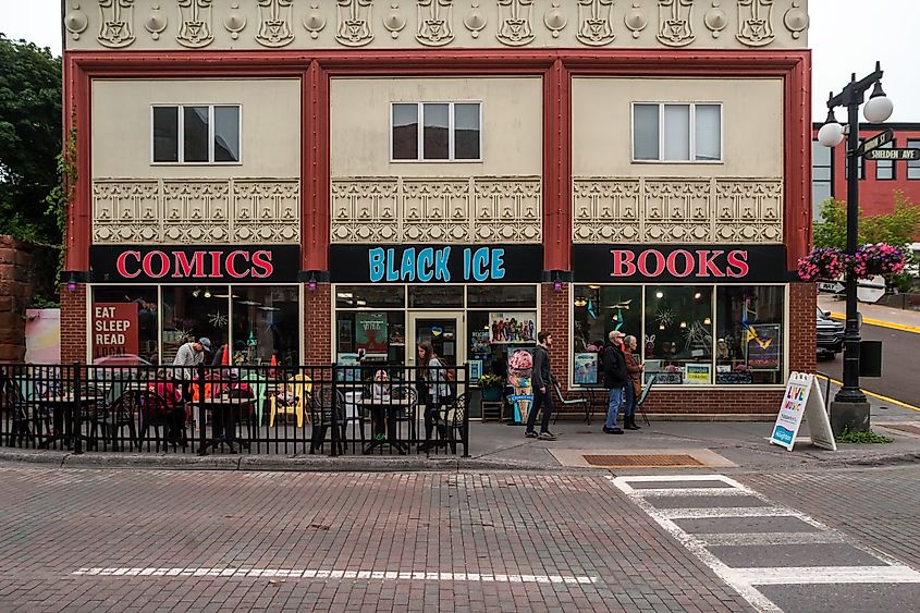 HOUGHTON, MI - SUMMER 2022 - A Wide Angle Street Shot of Black Ice Comics and Books Store on a Cloudy Summer Day