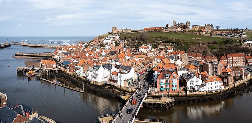An aerial landscape of the harbour and seaside town of Whitby in North Yorkshire with Whitby Abbey.