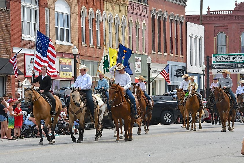 Members of the Local 4 H club ride their horses on Main Street in Council Grove, Kansas. Editorial credit: mark reinstein / Shutterstock.com