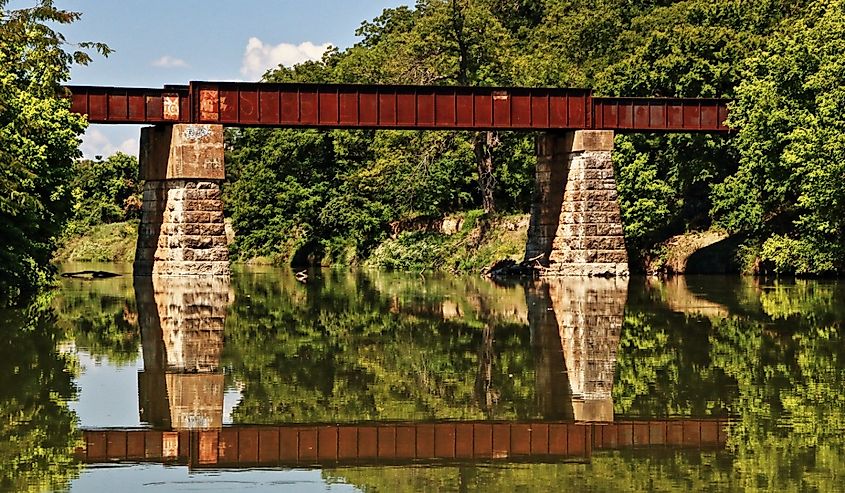 An old railroad trestle crosses the Bosque river at Clifton, Texas