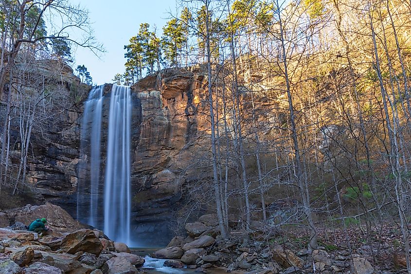 A photographer capturing a scene at the base of a waterfall in Toccoa, Georgia, United States of America.