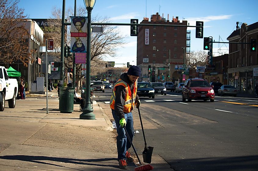 Man Cleaning Road Near Traffic Light (Image Credit: Denisse Leon via Unsplash.com)