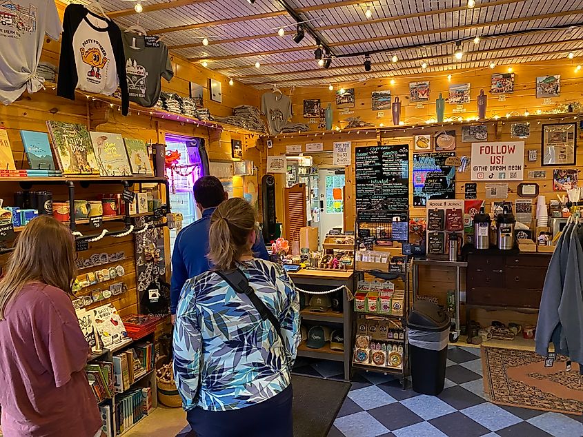 Coffeeshop goers queue inside of a quirky, homely cafe.