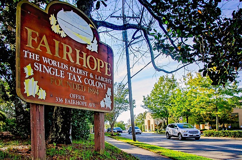 A sign welcomes visitors to Fairhope, Alabama, the worlds oldest and largest single tax colony. Image credit: Carmen K. Sisson / Shutterstock.com.