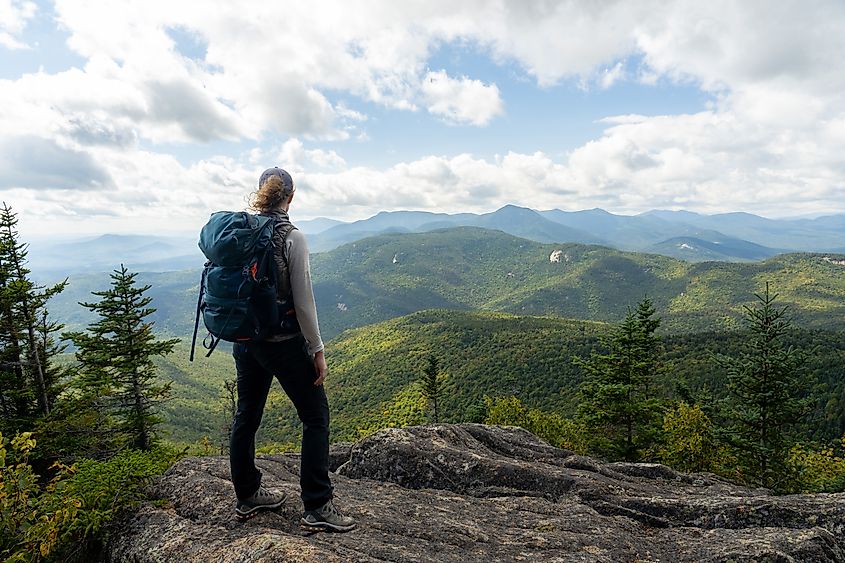 A hiker enjoying the spectacular view in Mount Chocorua, New Hampshire.