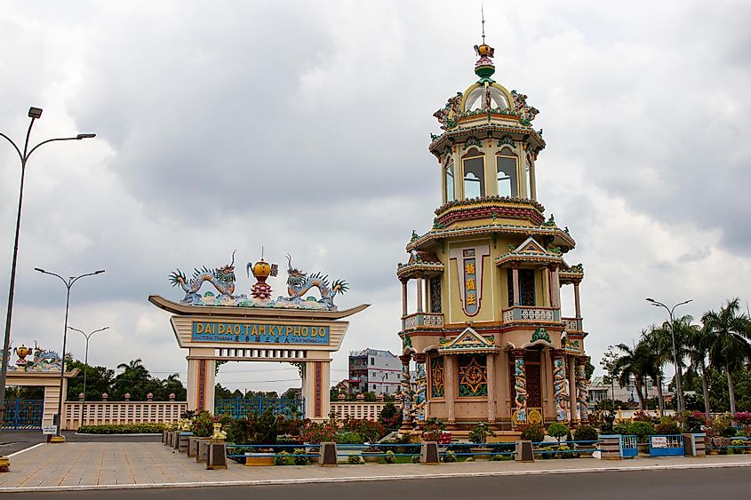 Tay Ninh, Vietnam - April 18, 2021: Gate And A Tower In Tay Ninh Holy See (Cao Dai Great Temple) In Central Of Tay Ninh City. Tay Ninh Holy See Is The Center Of Caodaism Faithful In South Vietnam.