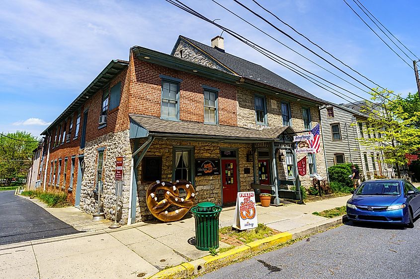 Exterior view of the Julius Sturgis Pretzel Bakery, the first commercial pretzel bakery in the US, with a distinctive large pretzel sign, via George Sheldon / Shutterstock.com