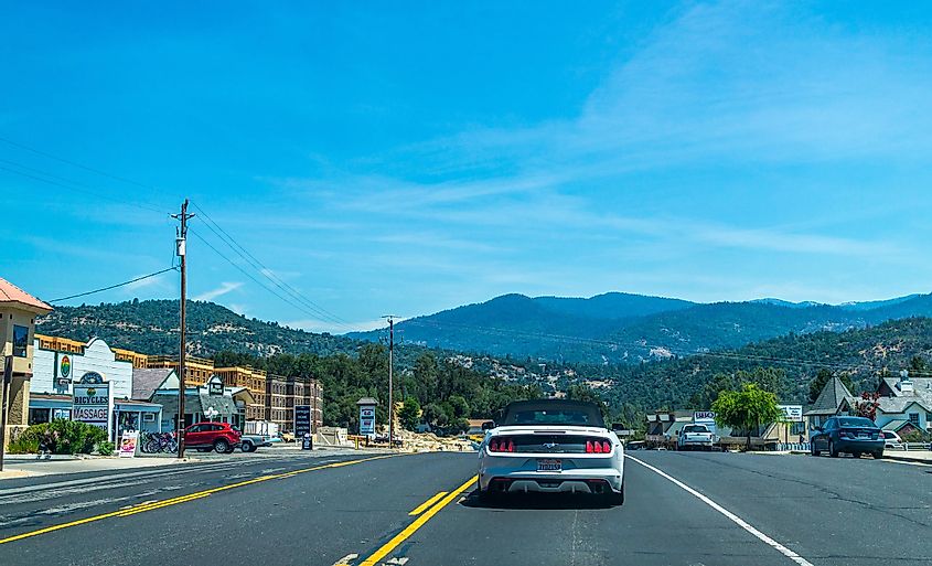  Oakhurst town in California and cars on the highway. Road to the Yosemite National Park.