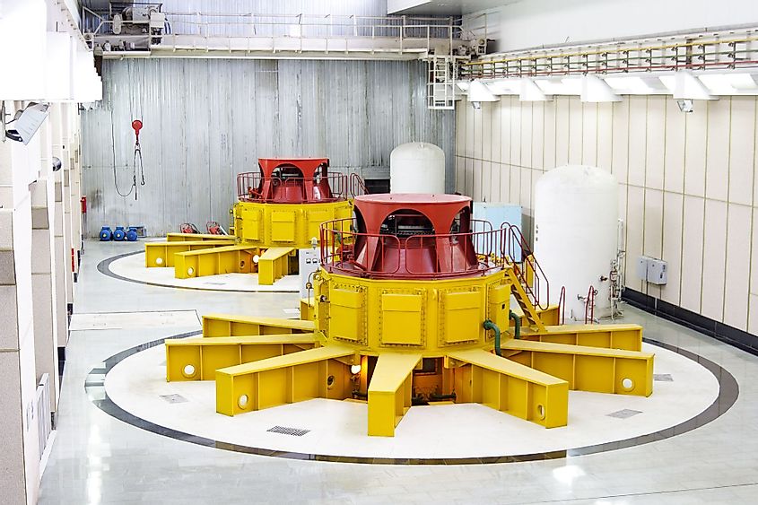 Huge water turbine generators inside a hydroelectric power plant.