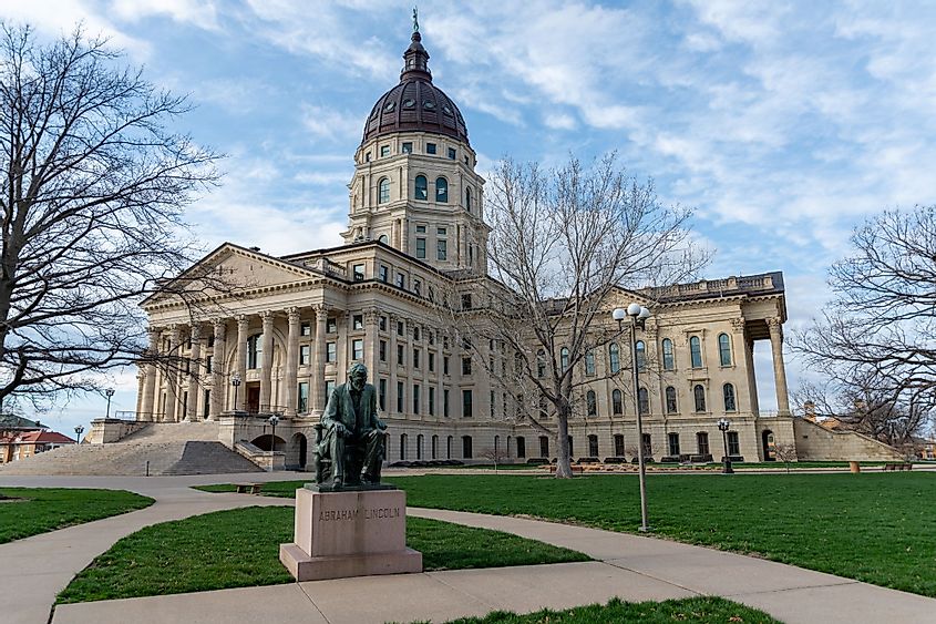 The Kansas State Capitol Building with the statue of Abraham Lincoln in the foreground in Topeka, Kansas