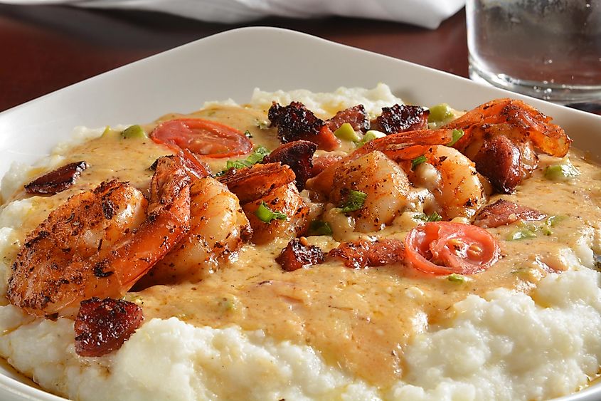 Sauteed shrimp, onions & tri color peppers with sausage, creole butter, on grits