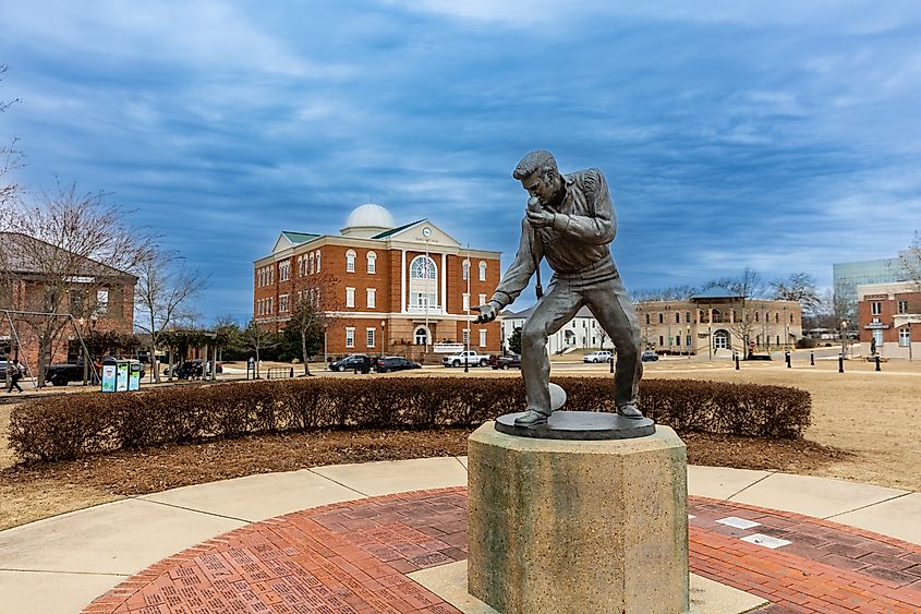 Elvis Presley Statue in Tupelo, Mississippi, with the City Hall in the background.