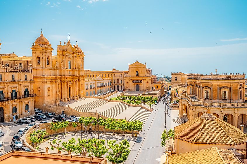 view in Noto, with the Basilica Minore di San Nicolo and Palazzo Ducezio, Sicily, Italy. (Credit: zedspider / Shutterstock)
