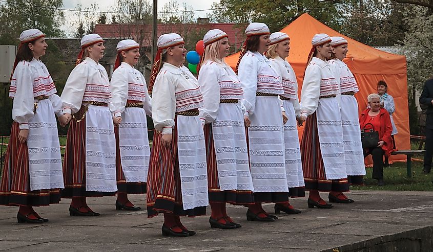 A group of women in national dress perform an Estonian folk dance.