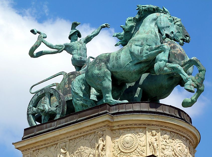 aged green bronze statue of man with snake on a chariot. the symbol of war. Heroes' square in Budapest, Hungary.